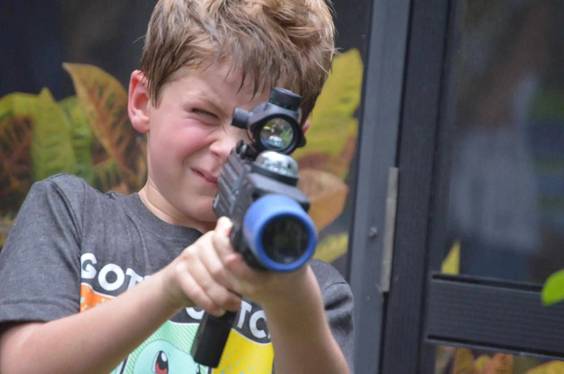 Player aiming a laser tagger during a close indoor game